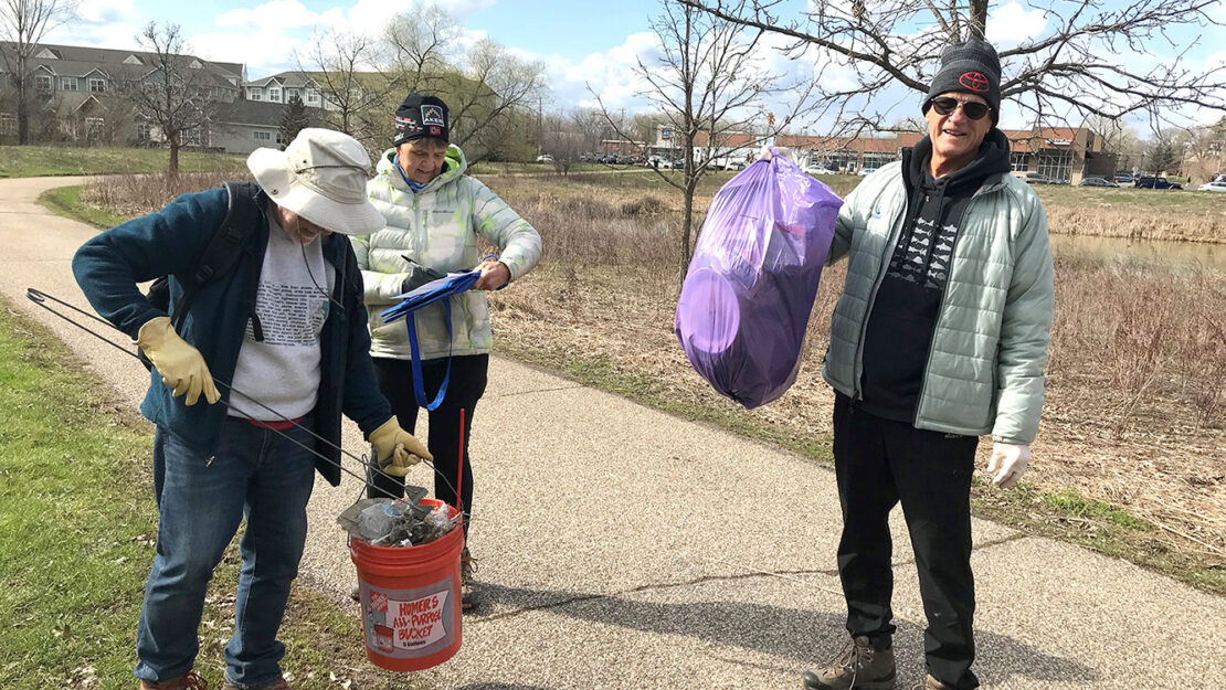 Three CAC members picking up garbage at Ames Lake